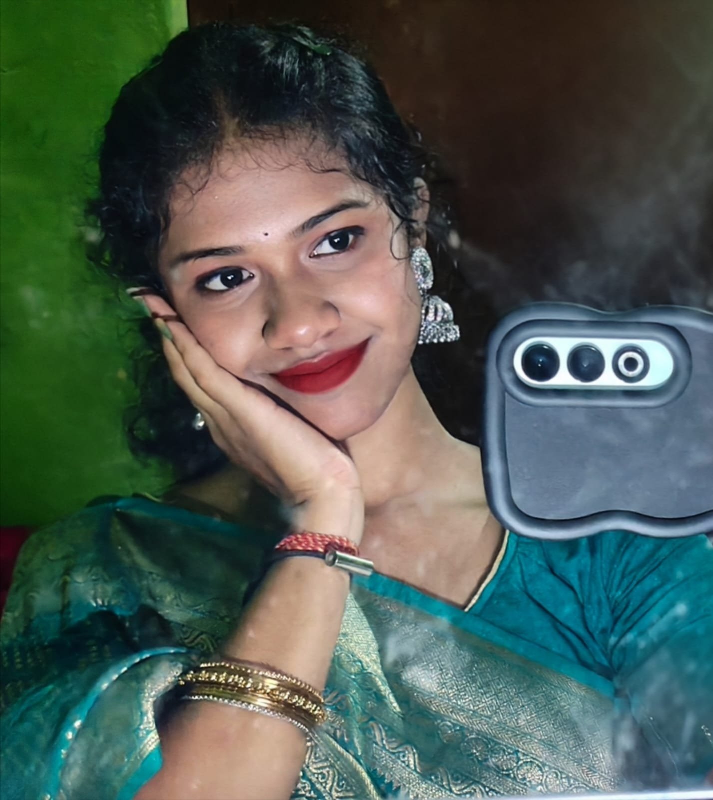 Pandill smiling in a teal sari