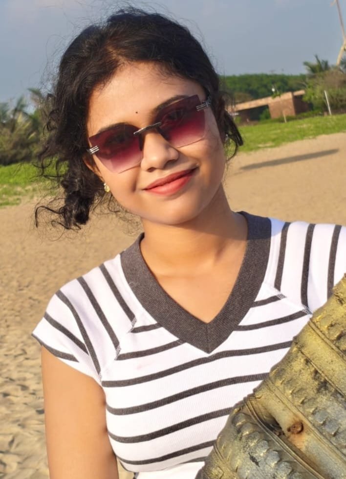 Pandill smiling in the sunshine at the beach