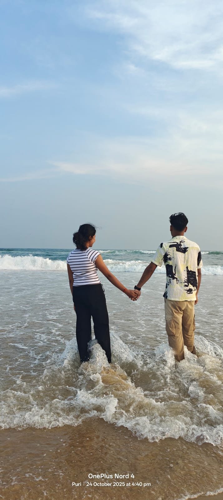 Holding hands together in the Puri waves